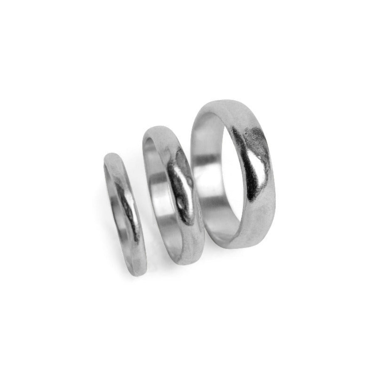 Three silver rings of different sizes on a white background