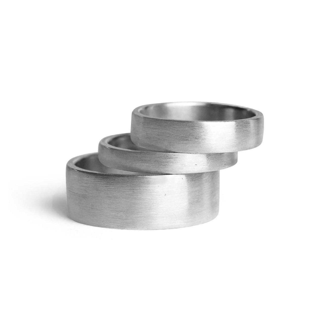 Three metallic rings stacked on a white background