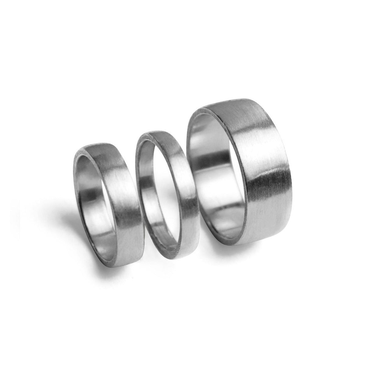 Three silver rings of different sizes on a white background
